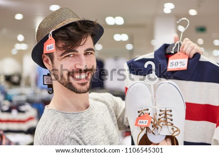 Happy young man shopping by fashion with 50% off discount