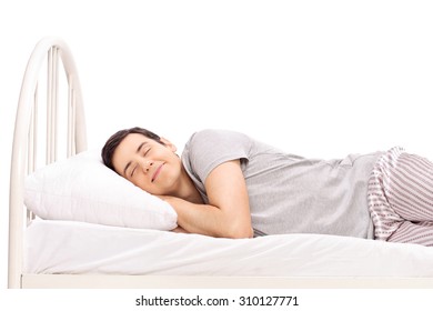 Happy Young Man Sleeping In A Bed Isolated On White