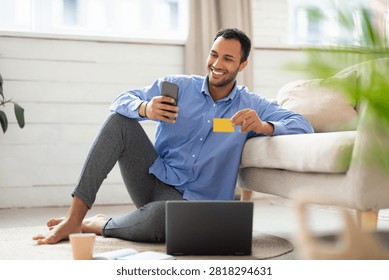 Happy Young Man Smiling While Shopping Online, Home Office Setting, Business Concept