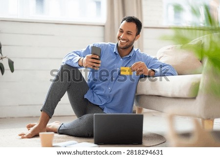 Happy Young Man Smiling While Shopping Online, Home Office Setting, Business Concept