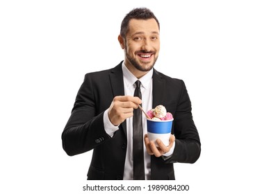 Happy Young Man In A Suit And Tie Eating Ice Cream In A Paper Cup Isolated On White Background