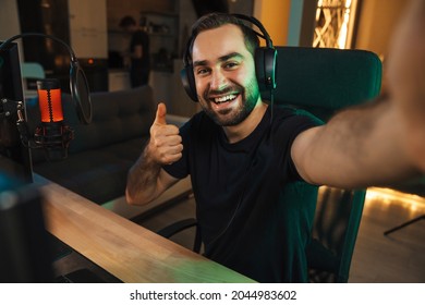 Happy Young Man Taking Selfie Photo While Playing Video Game On Computer At Home Celebrating Success