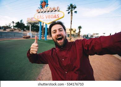 Happy Young Man Taking Selfie Near Las Vegas Welcome Sign. Handsome Having Fun Near Las Vegas Billboard On The Background, Nevada, USA