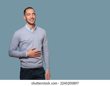 Happy young man thinking of food - Shutterstock ID 2245205897