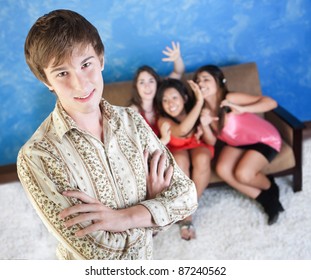 Happy young man with three adoring girls on sofa