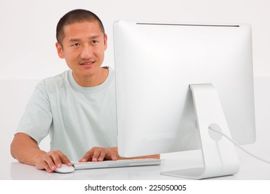 Happy young man using computer