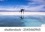 Happy young man and woman enjoying a trip to the famous Salinas Grandes in Argentina on a sightseeing tour on a sunny day with blue skies