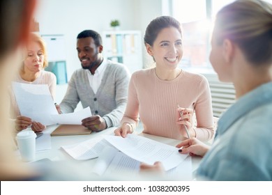 Happy Young Manager Or Accountant Looking At Her Colleague With Smile During Conversation