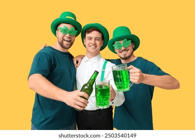 Happy young men in leprechaun's hats with beer on yellow background. St. Patrick's Day celebration - Powered by Shutterstock