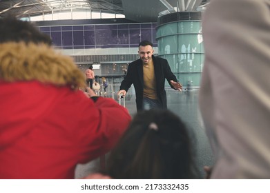 Happy Young Middle Eastern Man, Father Runs To Meet His Family After Business Trip At The International Airport Building. Long-awaited Meeting At The Airport Arrivals Terminal. Family Reunion Concept