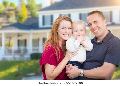 Happy Young Military Family In Front Of Their House.