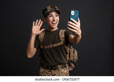 Happy Young Military Woman On A Video Call With Her Family Through Mobile Phone Isolated Over Black Background