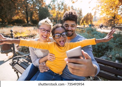 Happy Young Mixed Race Couple Spending Time With Their Daughter