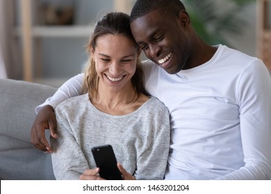 Smiling Young Couple Embracing While Looking Stock Photo 1446065777 ...