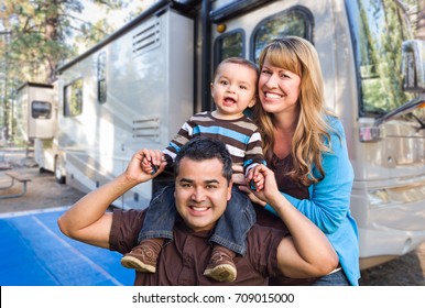 Happy Young Mixed Race Family In Front Of Their Beautiful RV At The Campground.