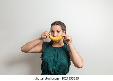 Happy Young Model Makes Banana Look Like Smile