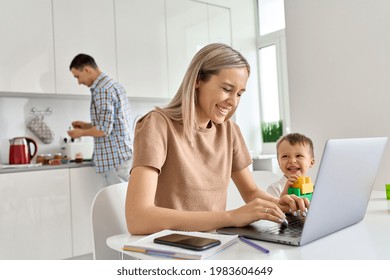 Happy young mom business woman distance working online using laptop computer while small funny kid son playing having fun sit at kitchen table. Virtual homeoffice work and child care in family life.