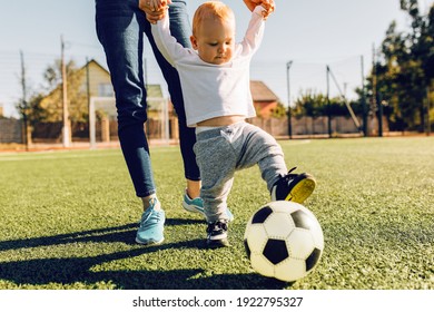 Happy Young Mom With Son Play Soccer On The Field, Outdoors