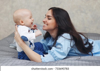 Happy Young Mother With The Baby Talk With A Smile