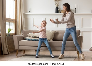 Happy Young Mother Dancing With Little Daughter, Funny Activity At Home, Enjoying Family Weekend Together, Preschool Girl With Older Sister Having Fun, Doing Exercises, Listening To Favorite Music