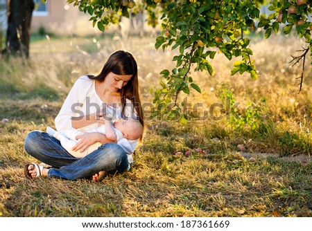 Similar – Image, Stock Photo Mother bottle feeding baby at home