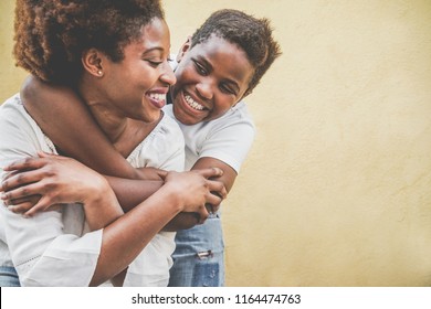 Happy Young Mother Having Fun With Her Child - Son Hugging His Mum Outdoor - Family Lifestyle, Motherhood, Love And Tender Moments Concept - Focus On Kid Face