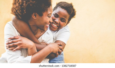 Happy Young Mother Having Fun With Her Kid - Son Hugging His Mum Outdoor - Family Connection, Motherhood, Love And Tender Moments Concept - Focus On Woman Eye