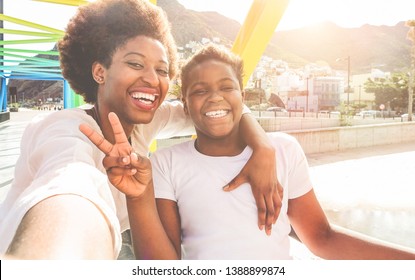 Happy Young Mother Having Fun With Her Child In Summer Sunny Day - Son Taking Selfie With His Mum Outdoor - Family Lifestyle, Motherhood, Love And Technology Concept - Main Focus On Woman Face