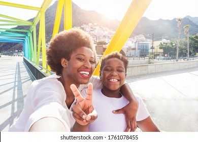 Happy Young Mother Having Fun With Her Child In Summer Sunny Day - Son Taking Selfie With His Mum Outdoor - Family Lifestyle, Motherhood, Love And Technology Concept - Main Focus On Woman Face