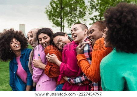 Happy young multi ethnic women having fun together in a public park - Diversity and friendship concept 