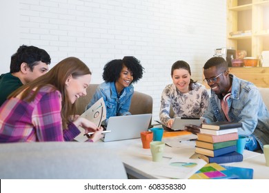Happy young multiracial group of young university students studying with books and laptop in cafe. Group of multiracial people in college library study.
