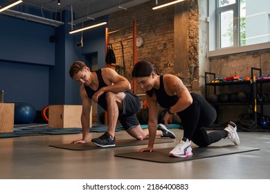 Happy Young Muscular Woman And Man In Fitness Gym During Class Workout Training