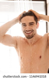 Happy Young Naked Man Having A Shower