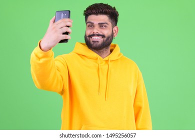 Happy Young Overweight Bearded Indian Man Taking Selfie