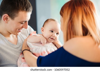 Happy Little Baby Girl Sitting On He Dads Stomach While Caring Young