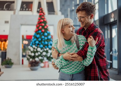 Happy young passengers standing at metro station, hugging and flirting. Trendy and urban affectionate couple is embracing and smiling at each other at subway. Urban romantic couple at train station. - Powered by Shutterstock