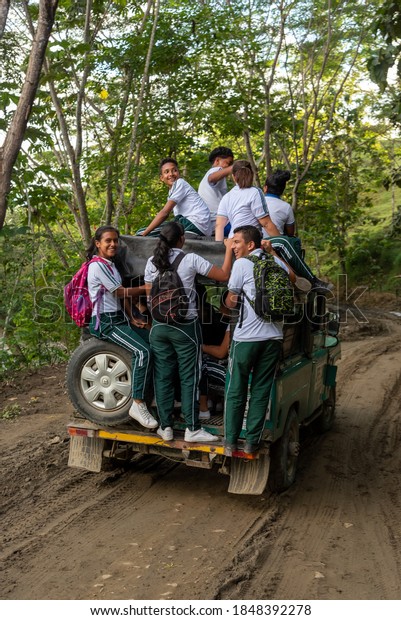 Happy young people in a 4x4 transport to go to\
school in a rural area. San José de Apartado. Antioquia. Colombia\
November 19, 2019.
