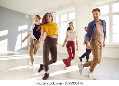 Happy young people dance in causal clothes in studio prepare for concert. Smiling energetic millennial diverse dancers training performing together at class or lesson. Hobby and entertainment. - Powered by Shutterstock