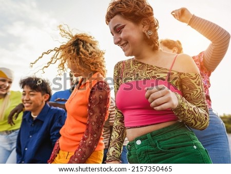 Happy young people dancing outdoor at festival event - Party and entertainment concept - Focus on right girl shoulder