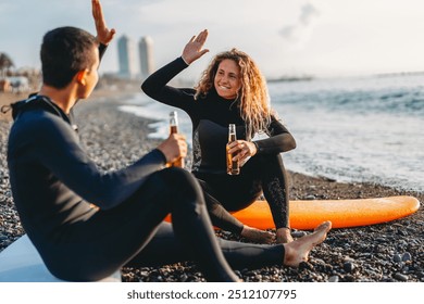 Happy young people, friends enjoying summer vacation with drink and surf at the beach - Powered by Shutterstock