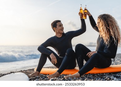 Happy young people, friends enjoying summer vacation with drink and surf at the beach - Powered by Shutterstock