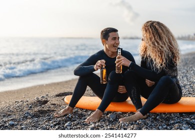 Happy young people, friends enjoying summer vacation with drink and surf at the beach - Powered by Shutterstock