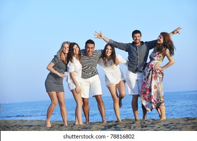 happy young people group have fun  run and jump  on beach beautiful sand  beach - Powered by Shutterstock