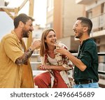 Happy young people having fun during a rooftop party during a summer holiday, standing on the rooftop terrace talking, eating and drinking, love, romance, relationship, flirting and youth culture 