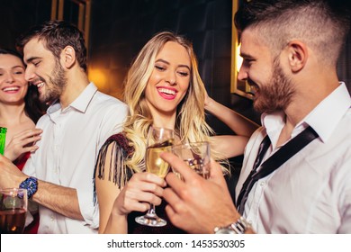 Happy young people having fun at nightclub. 