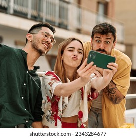 Happy young people having fun and making a selfie with a smartphone during a rooftop party during a summer holiday, standing on the rooftop terrace talking, eating and drinking, love, romance - Powered by Shutterstock
