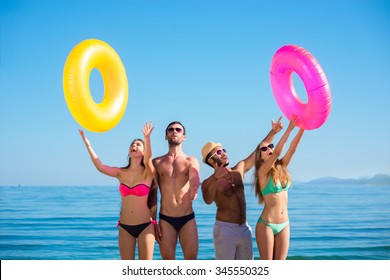 Happy Young People On The Beach. Summer Rest. Travel To The Ocean.  Summer Vacation At Sea. Holiday At Sea.