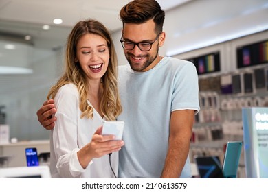 Happy young people shopping new mobile phone in a store. People technology device new concept - Shutterstock ID 2140613579