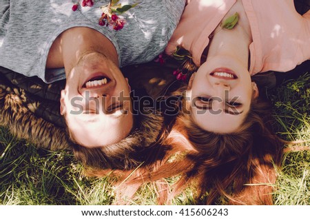 Similar – Women friends with sunglasses looking each other lying