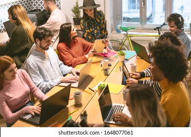 Happy Young People Working Together Inside Office - Multiracial Friends Having Fun In Coworking Space - Youth Co-workers Millennial Generation And Technology Workspace Concept 